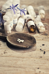 Fototapeta na wymiar Homeopathic bottle and Pills