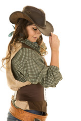 cowgirl with gun and holster touch hat look down