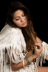 Native American woman in white outfit sit on black close look do