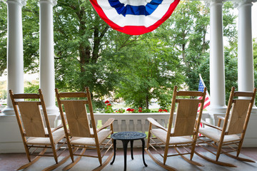 Four wooden rocking chairs and the American flag