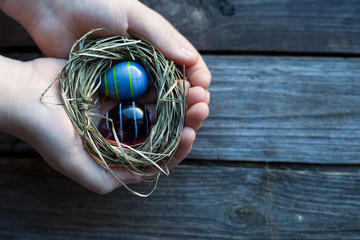 Fototapeta na wymiar easter decoration - glass eggs in hands