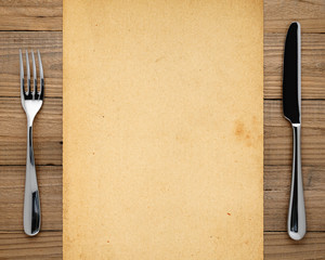 Old paper, fork and knife on wooden background - 79973605