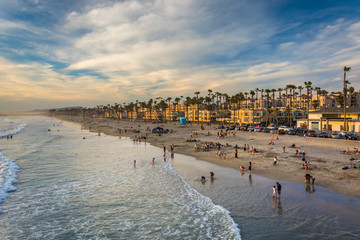 View of the beach from the pier in Oceanside, California. - Powered by Adobe