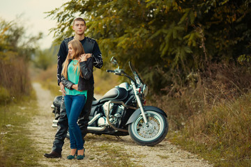 Obraz na płótnie Canvas Young couple with beautiful bike on road.