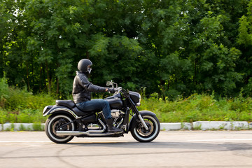 Fototapeta na wymiar slow motion, biker riding unknown motorbike with blur movement,