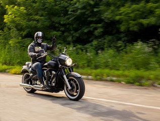 Fototapeta na wymiar slow motion, biker riding unknown motorbike with blur movement,
