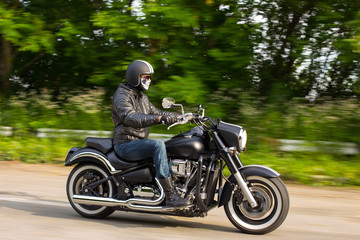 Obraz na płótnie Canvas slow motion, biker riding unknown motorbike with blur movement,