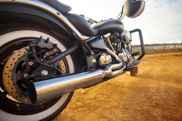 Fototapeta na wymiar Big, clean, black and unknown chopper bike in desert