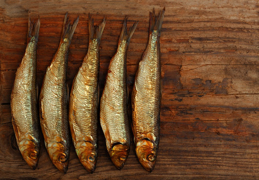 herring sprat fish smoked wooden table