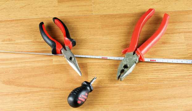 Pliers, screwdriver and measuring tape