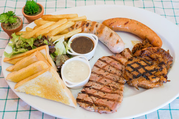 Steak and pork chop sausage serve with gravy sauce.