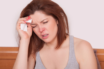 Obraz premium Sick Woman Caught Cold. Sneezing into Tissue. Headache