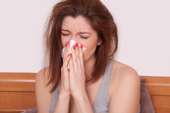 Sick Woman Caught Cold. Sneezing into Tissue. Headache