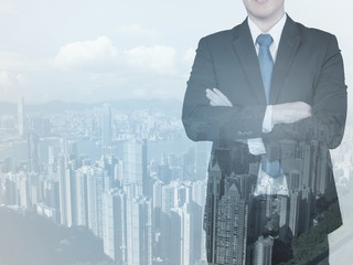 Double exposure of businessman and city