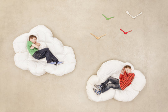 Boys lying on clouds sleeping