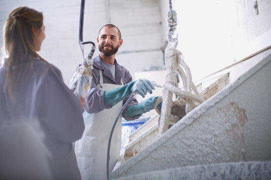 South Africa, Cape Town, Craftspeople preparing ceramic shell around casting mold