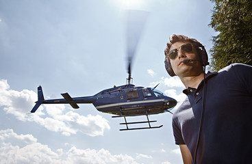 Germany, Bavaria, Landshut, Air traffic controller securing landing and take off of helicopter