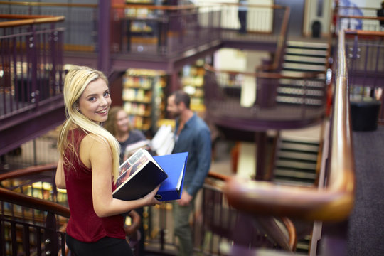 Portrait of smiling female student in a library