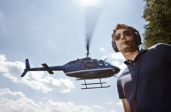 Germany, Bavaria, Landshut, Air traffic controller securing landing and take off of helicopter