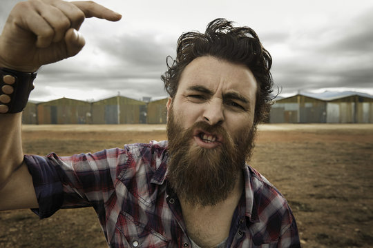 Angry man with full beard shouting at camera