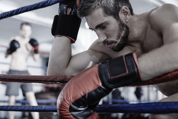 Boxer resting at the side of boxing ring