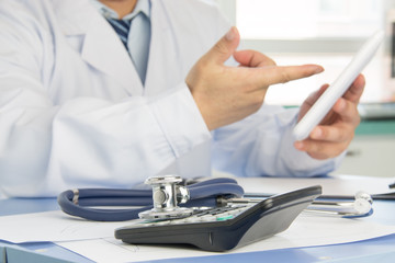 Close-up of stethoscope on background of doctors at work