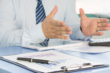 Businessman analyzing financial statements in the office