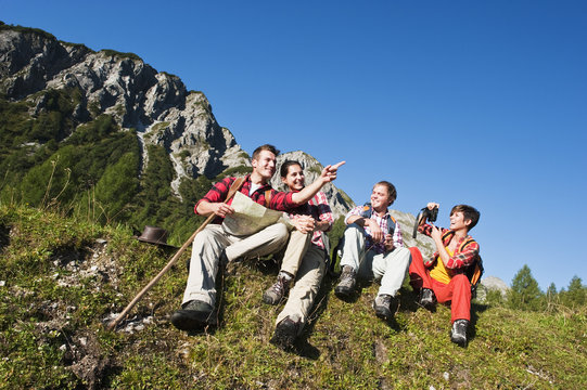 Austria, Salzburg County, Men and women sitting in alpine meadow
