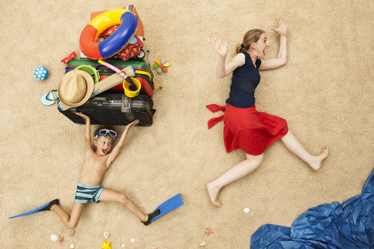 Germany, Mother and son with toys and baggage at beach