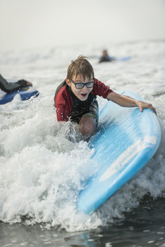 Portrait of boy learning surfboarding