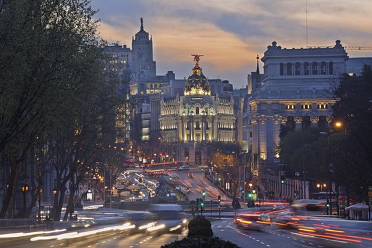 Madrid, View of Calle de Alcala and Plaza de Cibeles, Edificio Metropolis blurred traffic at dusk