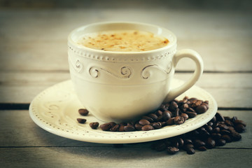 Cup of coffee on wooden table, close up