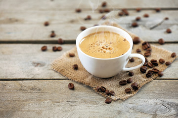 Cup of coffee on wooden table, close up