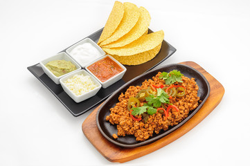 Fried minced beef on hot plate with sauce and crispy flapjacks