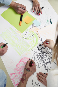 Creative professionals drawing on paper