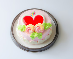 Cake flower and heart topping (focus on flower) bakery