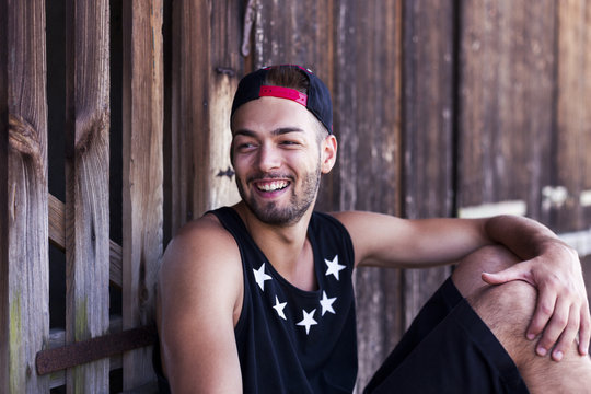 Portrait of smiling young man wearing baseball cap