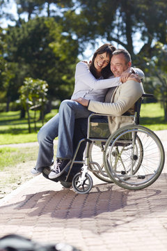 Woman hugging man in wheelchair
