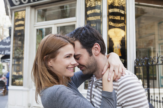 France, Paris, couple in love in front of pastry shop