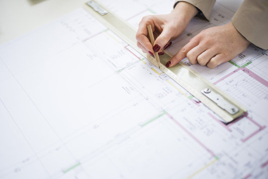 Close-up of architect working on construction plan