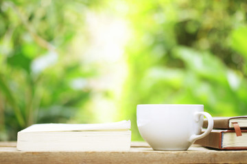 Notebook  and coffee on wooden table