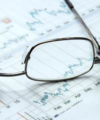 Eyeglasses lying down on a business document