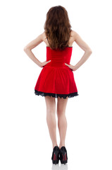 Young female model posing in red mini dress