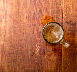 Glass of beer on the wooden grunge table.