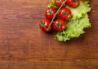 Fresh cherry tomatoes on rustic wooden background
