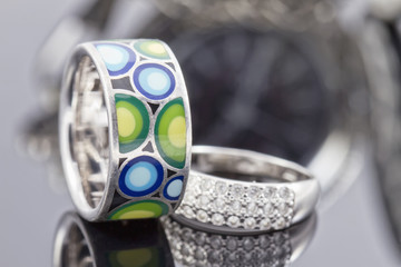 silver ring with precious stones and ring with colored enamel