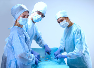 Team surgeon at work in operating room.