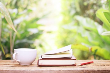 Notebook  and coffee on wooden table