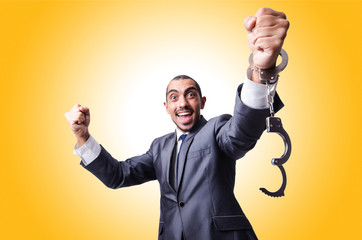 Funny businessman with handcuffs on white