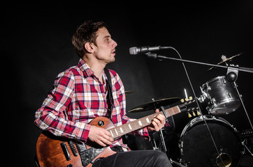 Fototapeta premium Man with guitar during concert